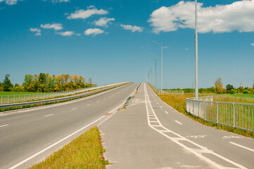 Empty bike path in country near roadway in summer