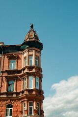 Facade of antique brick house on blue sky background