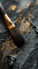 Close Up of a Black Paintbrush on a Dark Surface Showcasing the Intricacies of Artistic Tools and Their Role in Creating Stunning Visuals