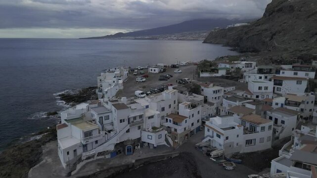 Drone flies south over coastal town in El Varadero, Canary Islands, Spain and then the sea toward Candelaria