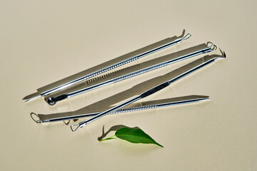 Tools for mechanical facial cleansing at home or at a cosmetologist on a beige background.