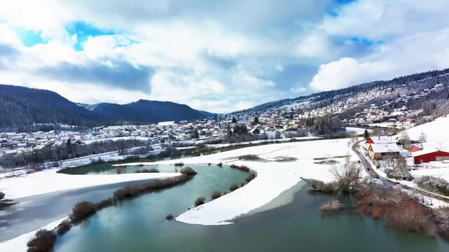 Aerial view of River Doubs winding through village, France.