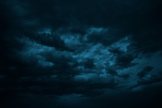 Dramatic sky with clouds. Black dark blue green night sky. Thunderstorm storm. Ominous,  frightening. 