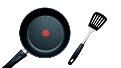 Frying pan with red indicator and slotted spatula on kitchen cooking
