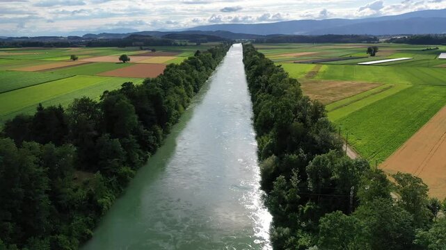 Aerial view of tranquil river and fields, Switzerland.