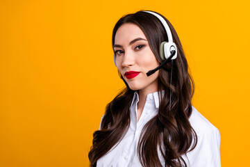 Professional woman with headset on yellow background ready for business communication or customer...