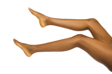 Studio shot of black woman’s bare legs and feet in a beauty pose on white background