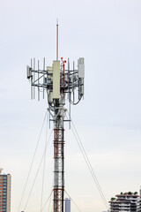 Wireless Communication Antenna pole, Mobile phone mast antenna pole on top of dilapidated building