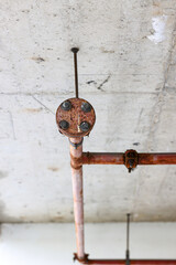 Old steel metal pipe of Fire extinguishing system attached to the wall in Construction.
