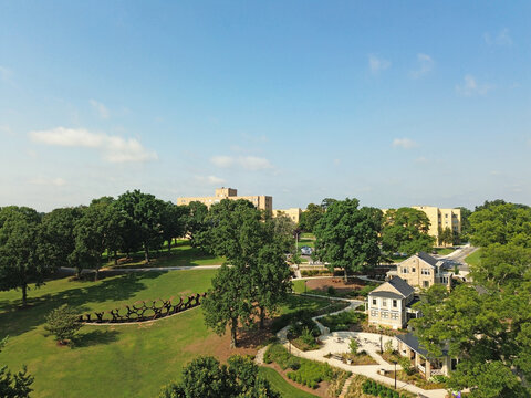 Raleigh, NC - USA - 7-8-2025:  The Attun sculpture by artist DeWitt Godfrey and the historic stone houses at Dix Park in downtown Raleigh