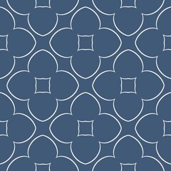 A geometric pattern featuring interlocking floral shapes is set against a muted gray background. The design is thoughtfully symmetrical, creating a sense of balance and harmony.