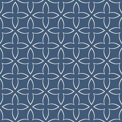 A symmetrical pattern forms rows of interconnected floral shapes on a dark gray background. The design consists of repeating geometric motifs that create a harmonious and balanced appearance.