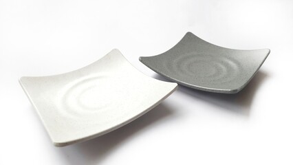 Empty square white and grey plates with ceramic melamin material isolated on white background