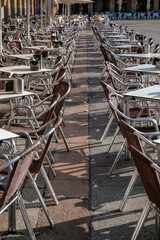 Vertical view of metallic tables and chairs in a restaurant