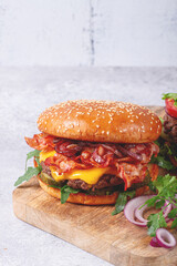 burger with beef and bacon, with arugula and caramelized onions, pickles, sauce, homemade, no people,