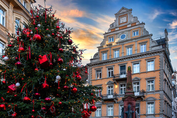 Constance town square with decorated Christmas tree, fairy lights, and decorated old town building at sunset