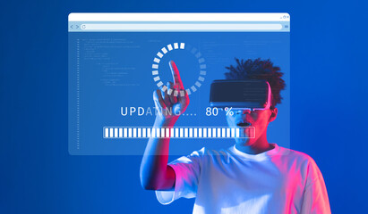 A person interacts with a virtual reality interface, showcasing an update process. The visual...
