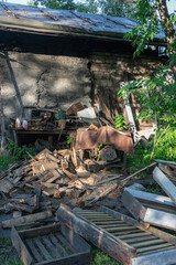 A scene of decay and abandonment featuring a shed and wooden debris.