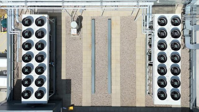 Aerial drone top down view data center centre cooling fans quantum computing distribution warehouse industrial area near Peterborough England UK
