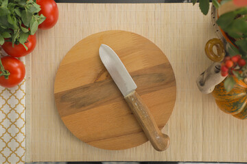 Rustic Wooden Cutting Board with Knife Surrounded by Fresh Tomatoes