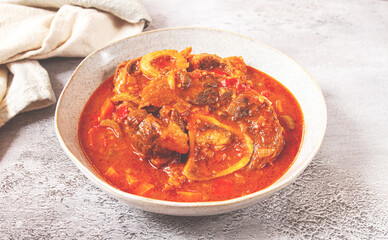 ossobuco, stewed meat knuckle on the bone, with oats and spices, homemade, no people,