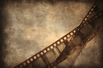 Old film strip on grunge background representing history of cinema