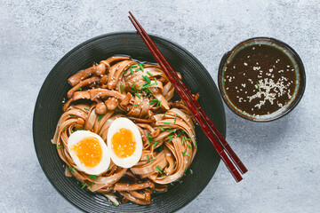 buckwheat noodles soba with shimeji mushrooms, with boiled egg, green onion, sesame seeds,...