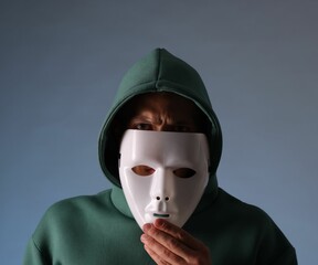 Anonymity. Man wearing mask on grey background