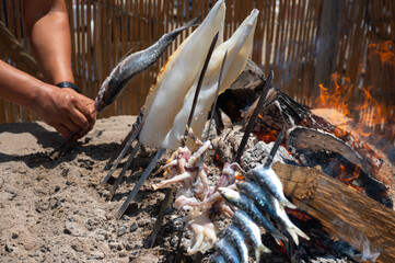 Man Grilling Seafood Espeto Over Fire