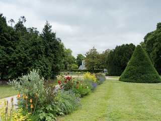 Gardens of the navy 'Jardins de la Marine' of  Rochefort in Charente-Maritime. Flowery and green area in a shaded setting overlooking the Corderie Royale on the bank of the Charente River
