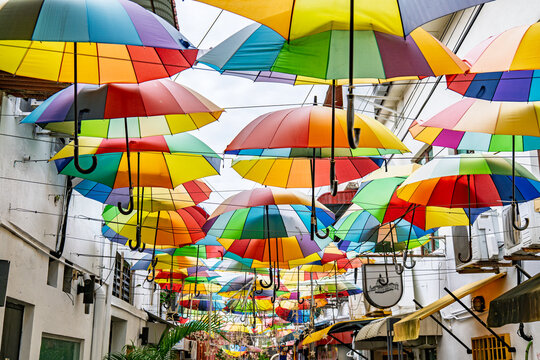 Colourful rainbow of umbrellas shade a laneway off Armenian St in George Town's heritage area.