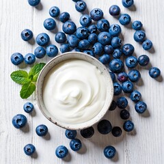 Yogurt sits in bowl surrounded by blueberries