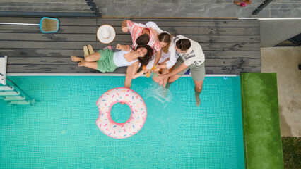 A cheerful scene of friends enjoying drinks by the pool, radiating happiness and making lasting...