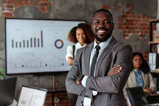 Confident businessman smiling with folded arms during presentation in modern office