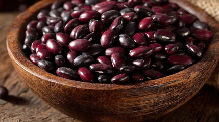 Close-up of dark red beans in a wooden bowl