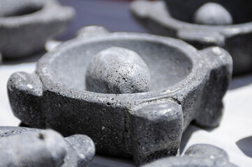 Traditional volcanic stone grinding stone (molcajete) in close-up.