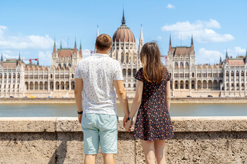 Couple admiring Budapest Parliament from across the Danube