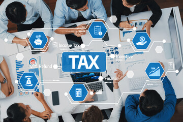 A diverse team engages in a collaborative business meeting focused on tax planning, utilizing charts and technology to enhance financial strategies and insights. Amity