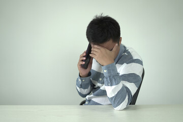 Young asian businessman suffering headache, backache and neck pain while working for so long,...