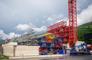 Colorful construction crane parts stored outdoors at industrial site