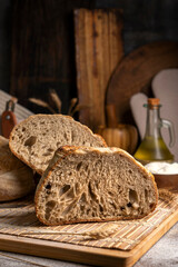Healthy, organic, whole and sliced ​​homemade sourdough bread with ham and cheese on a wooden...