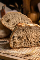 Healthy, organic, whole and sliced ​​homemade sourdough bread with ham and cheese on a wooden...