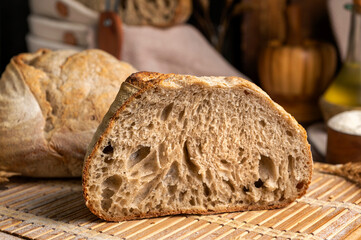 Healthy, organic, whole and sliced ​​homemade sourdough bread with ham and cheese on a wooden...
