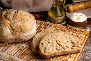 Healthy, organic, whole and sliced ​​homemade sourdough bread with ham and cheese on a wooden...