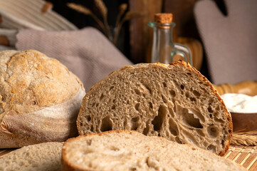 Healthy, organic, whole and sliced ​​homemade sourdough bread with ham and cheese on a wooden...
