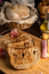 Healthy, organic, whole and sliced ​​homemade sourdough bread with ham and cheese on a wooden...