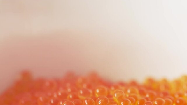 Falling red caviar closeup macro view. Background. Delicacy product of the highest quality, 4k