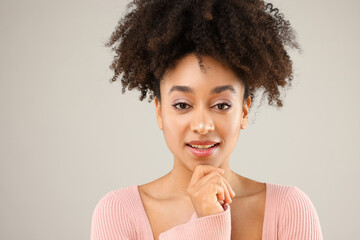 Portrait of beautiful Brazilian woman on gray background
