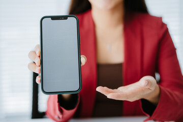 Close-up of a young woman holding a smartphone, typing a message, talking with friends. on social networks Concept of using mobile application, online shopping, opening website, ordering food, busines