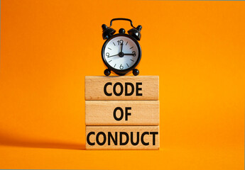 Code of conduct symbol. Wooden blocks with words Code of conduct with alarm clock. Beautiful orange...